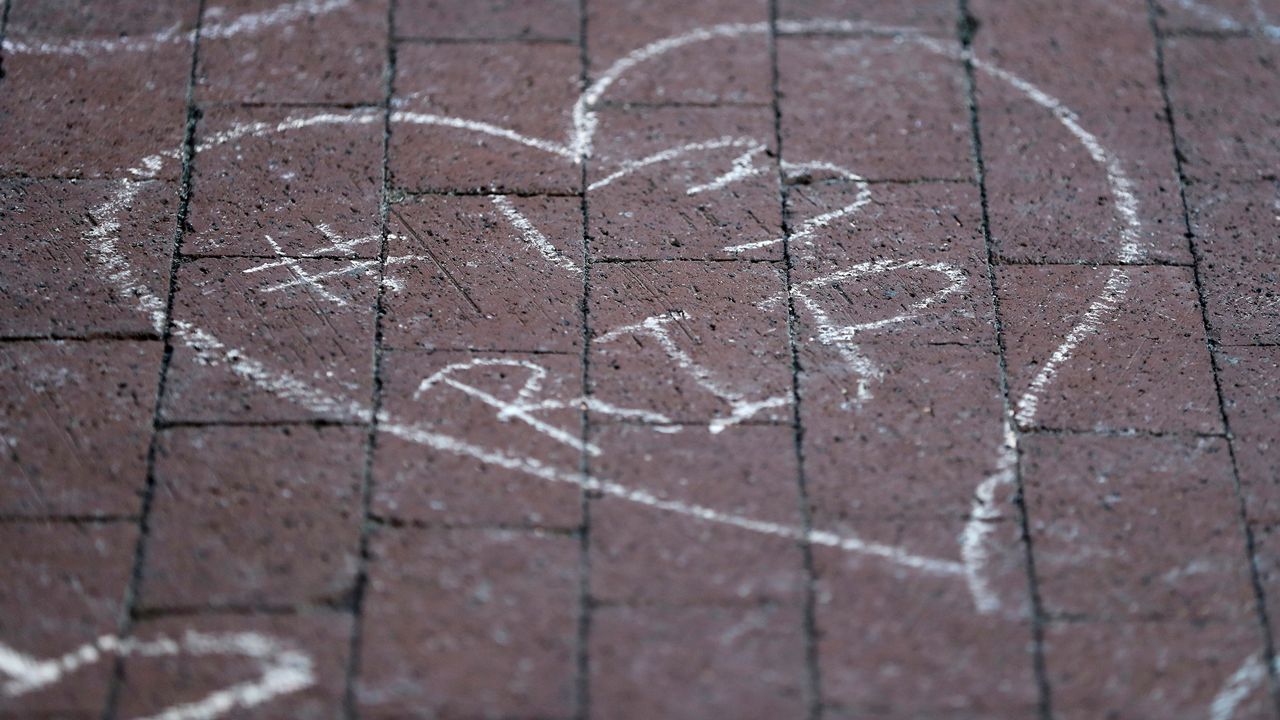 Columbus Blue Jackets fans leave chalk messages during the candlelight vigil to honor Blue Jackets hockey player Johnny Gaudreau, Thursday, Sept. 4, 2024, outside of Nationwide Arena in Columbus, Ohio. Gaudreau and his brother Matthew were killed by a motor vehicle last week while riding bicycles. (AP Photo/Joe Maiorana)