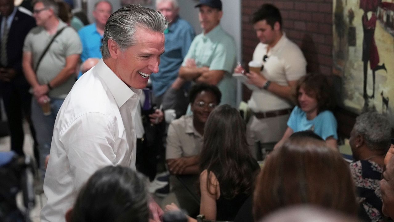 Gov. Gavin Newsom, D-Calif., greets people in a coffee shop during a two-day swing through South Carolina on Tuesday, July 8, 2025, in Florence, S.C. (AP Photo/Meg Kinnard)