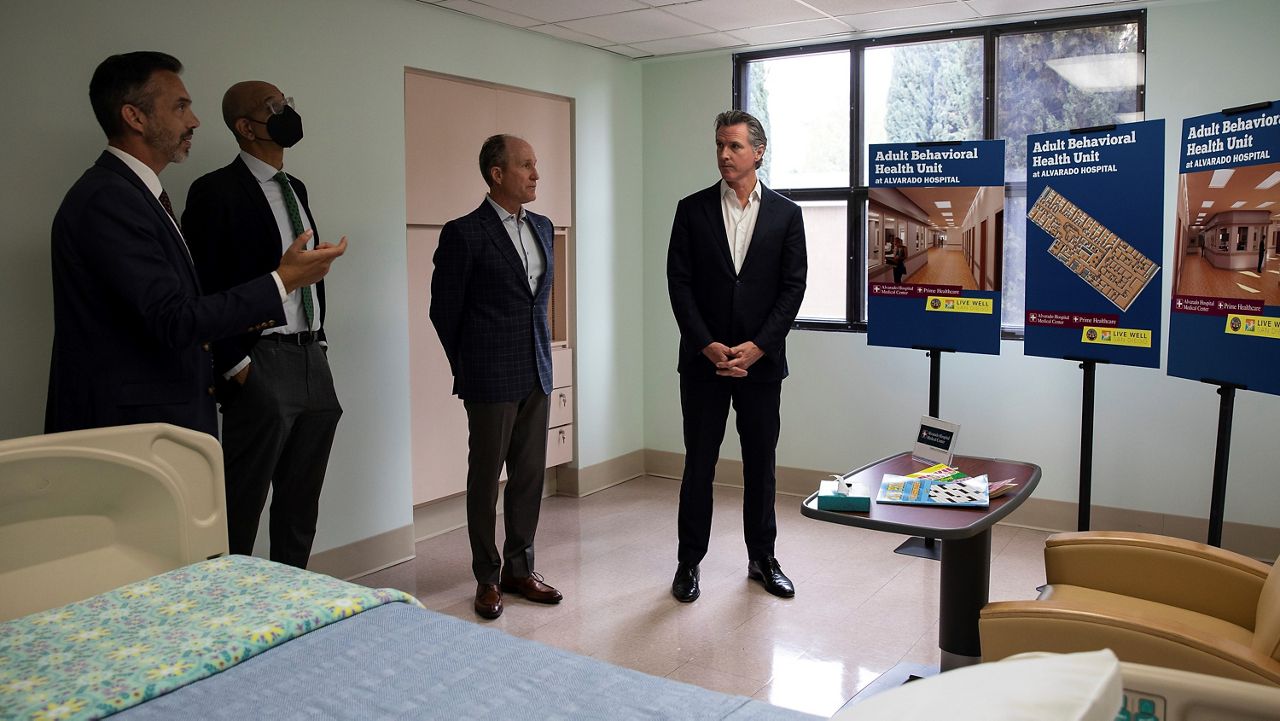 From left to right: Dr. Luke Bergmann, director of San Diego County Behavioral Health Services; Dr. Mark Ghaly, secretary of California Health and Human Services; Ken McFarland, CEO of Alvarado Hospital and Gov. Gavin Newsom tour a room at the adult behavioral unit ahead of a news conference announcing a proposed a 2024 ballot initiative to improve mental health services across the state, at Alvarado Hospital in San Diego, Sunday, March 19, 2023. (Adriana Heldiz/The San Diego Union-Tribune via AP, Pool)