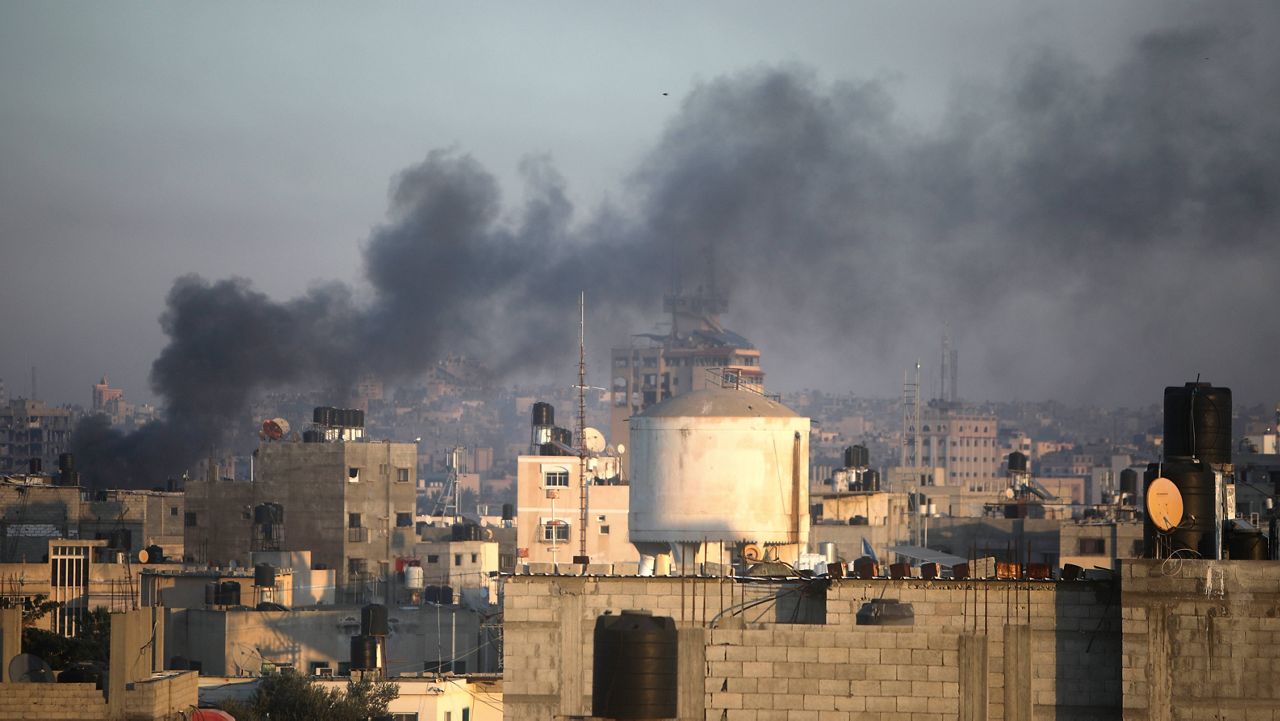 Smoke rises from town of Khan Younis after Israeli strikes on Friday, Dec. 15, 2023. (AP Photo/Mohammed Dahman)