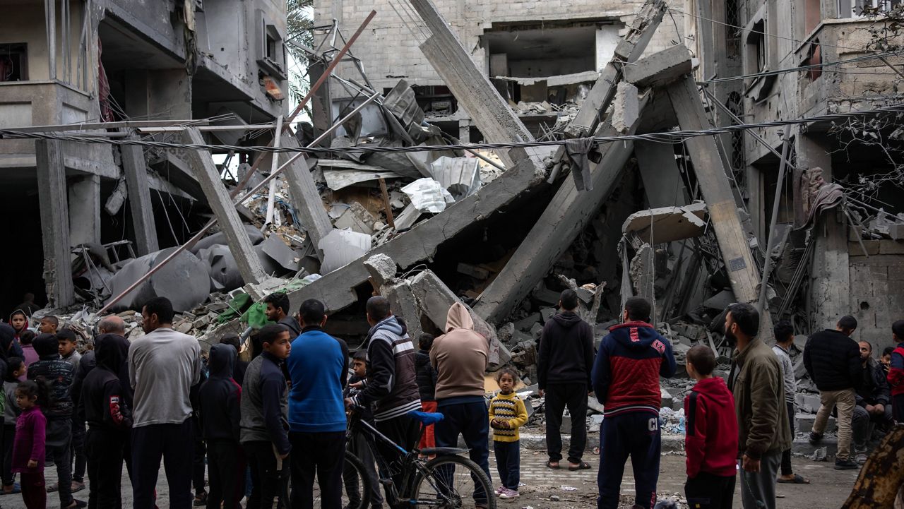Palestinians inspect the damage of residential buildings after an Israeli airstrike in Rafah, southern Gaza Strip, Sunday, March 24, 2024. (AP Photo/Fatima Shbair)