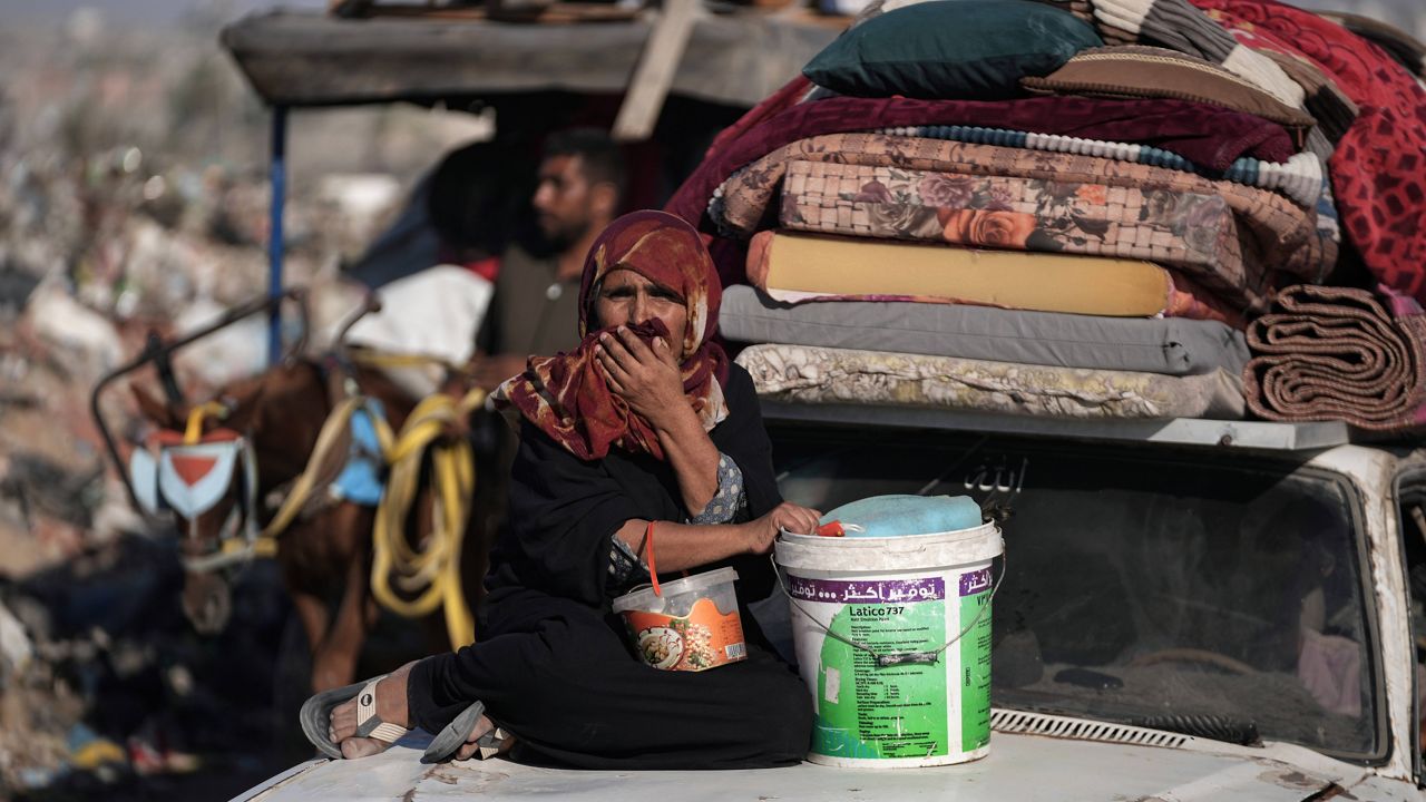 A Palestinian woman flees the Khan Younis area of the Gaza Strip, following Israeli military evacuation orders, saying its forces will soon operate there, Thursday, Aug. 8, 2024. (AP Photo/Abdel Kareem Hana)