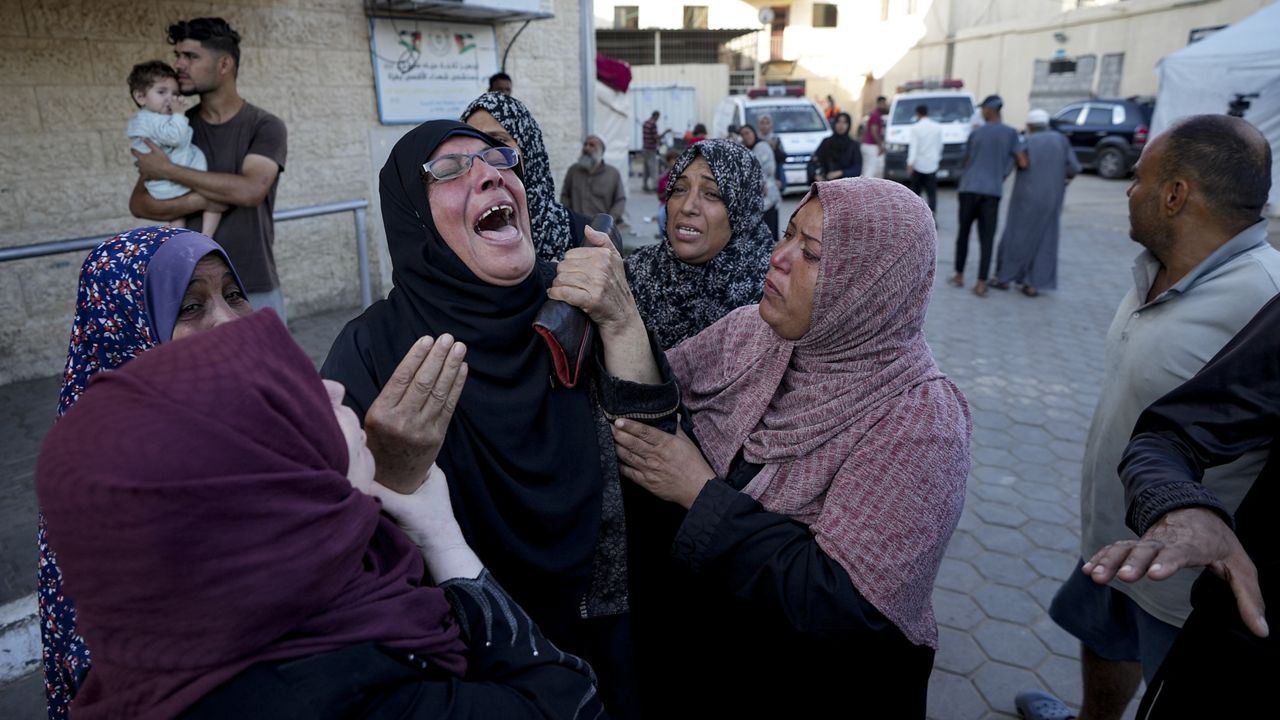 Palestinians mourn for relatives killed in the Israeli bombardment of the Gaza Strip at a hospital morgue in Deir al-Balah, Wednesday, Oct. 2, 2024. (AP Photo/Abdel Kareem Hana)