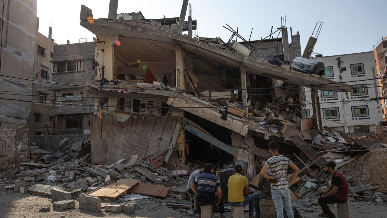 Palestinians on Monday inspect their house, which was hit by an Israeli airstrike in Gaza City. (AP Photo/Fatima Shbair)