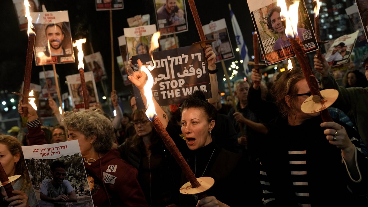 Relatives and friends of people killed and abducted by Hamas and taken into Gaza react to the ceasefire announcement as they take part in a demonstration in Tel Aviv, Israel, Wednesday, Jan. 15, 2025. (AP Photo/Oded Balilty)