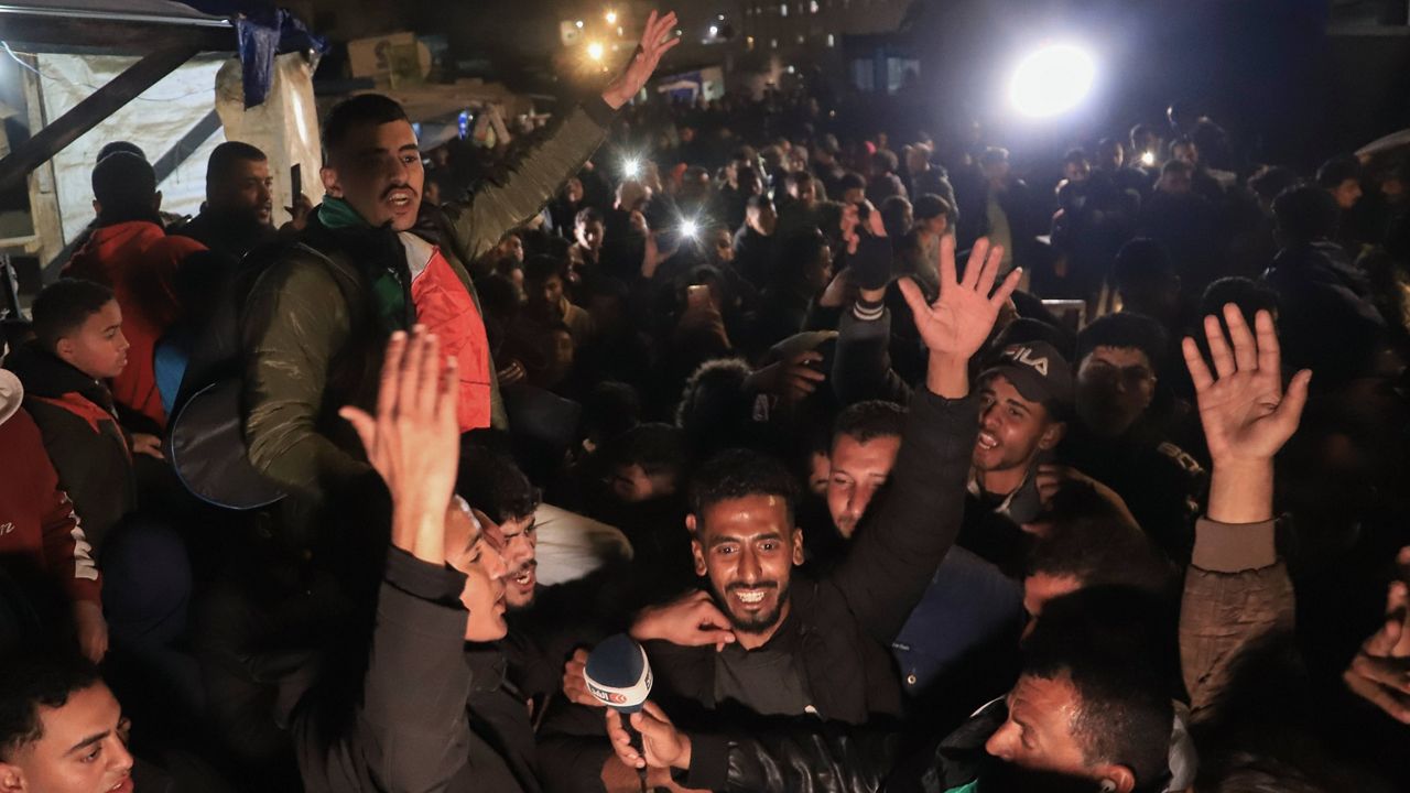 Palestinians celebrate the imminent announcement of a ceasefire deal between Hamas and Israel in Khan Younis, central Gaza Strip, Wednesday, Jan. 15, 2025. (AP Photo/Mariam Dagga)