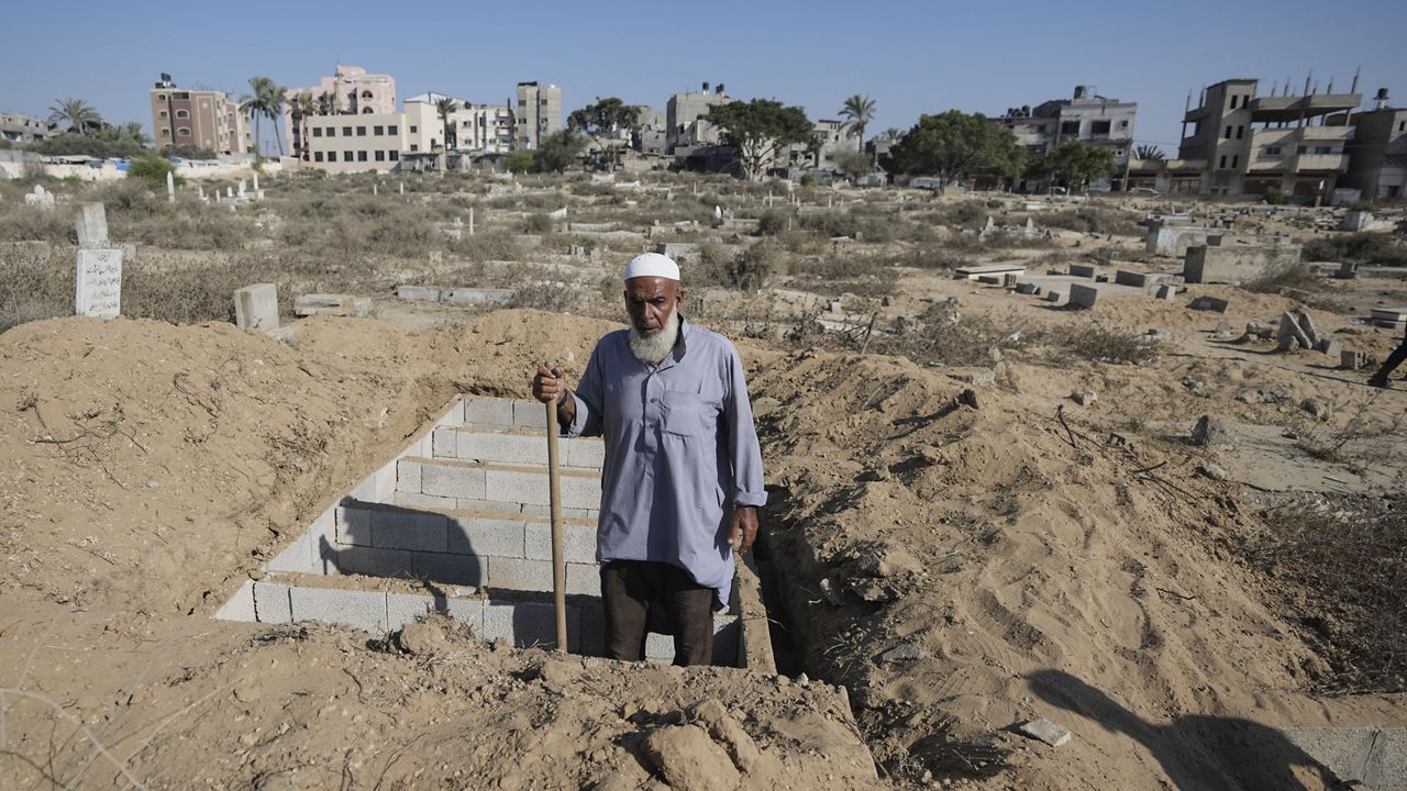 Palestinian grave digger Sa'di Baraka pauses while digging new graves in a cemetery in Deir al-Balah, Gaza Strip, Friday, Aug. 2, 2024, making room for more killed in the 10-month-old war. (AP Photo/Abdel Kareem Hana)