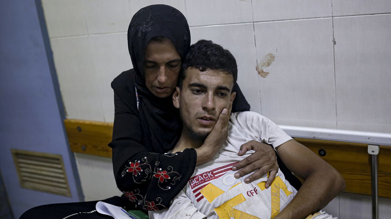 In a hospital in Khan Younis, Gaza Strip, a Palestinian woman hugs her son who was wounded in the Israeli bombardment, Tuesday, July 9, 2024. (AP Photo/Jehad Alshrafi)