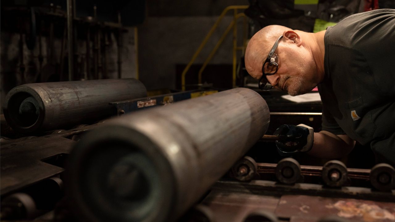 A steel worker inspects a 155 mm M795 artillery projectile during the manufacturing process at the Scranton Army Ammunition Plant in Scranton, Pa., on April 13. (AP Photo/Matt Rourke, File)
