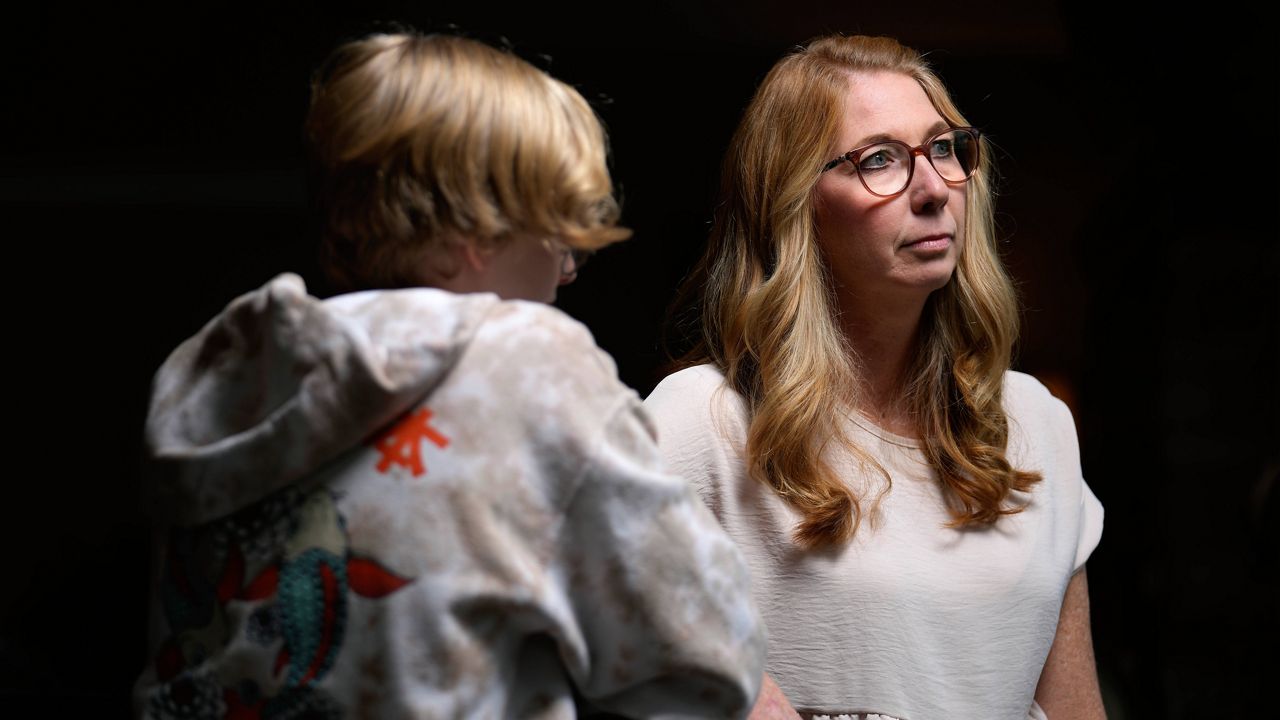 Becky Hormuth poses for a photo with her son Wednesday, Sept. 20, 2023, in Wentzville, Mo. About four years ago Hormuth's child, now a 16-year-old junior at a suburban St. Louis high school, came out as transgender. (AP Photo/Jeff Roberson)