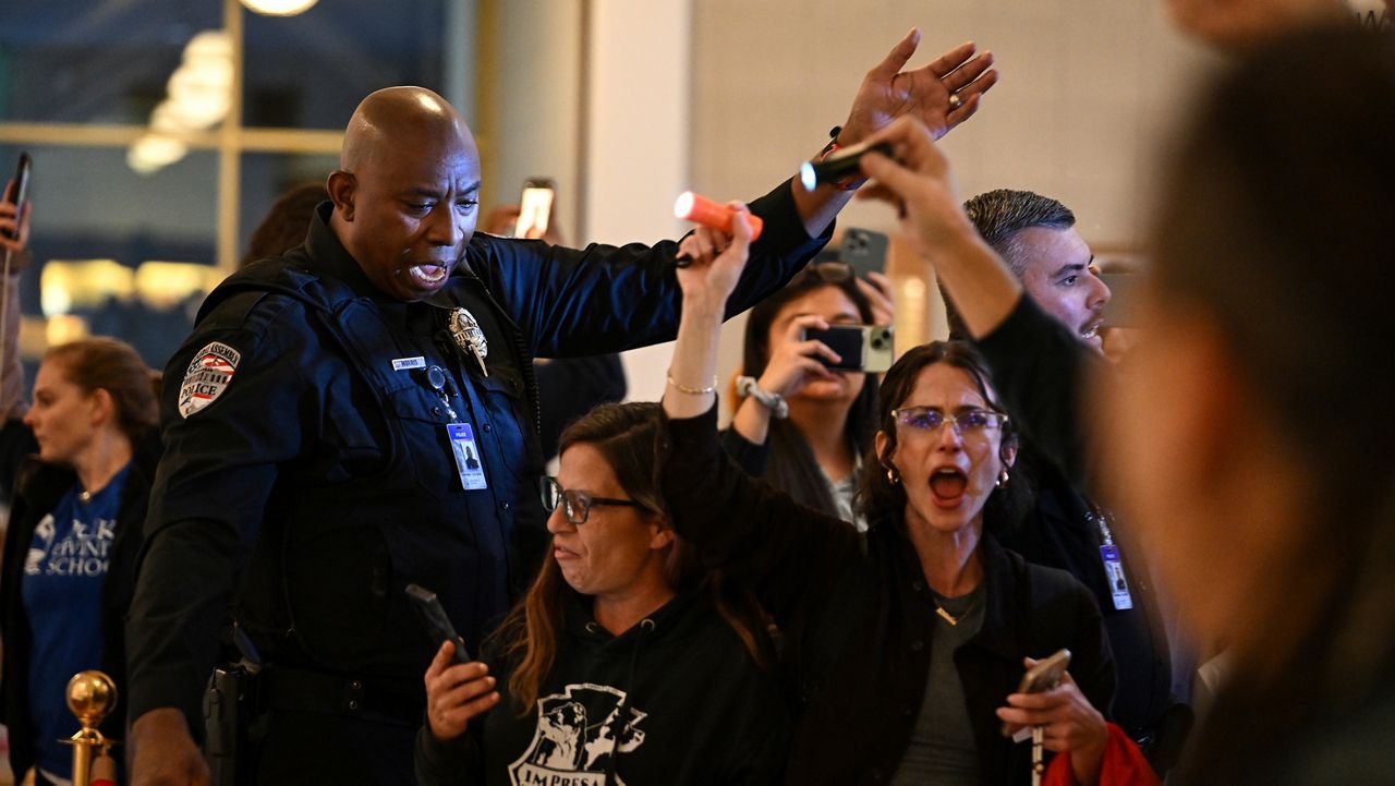A General Assembly police officer escorts protesters after the Republican-dominated state House completed the override of Democratic Gov. Roy Cooper's veto of a bill that aims to weaken the powers of Cooper's soon-to-be successor and other Democratic statewide winners in the Nov. 5 elections on Wednesday, Dec. 11, 2024, in Raleigh, N.C. (AP File Photo/Matt Kelley)