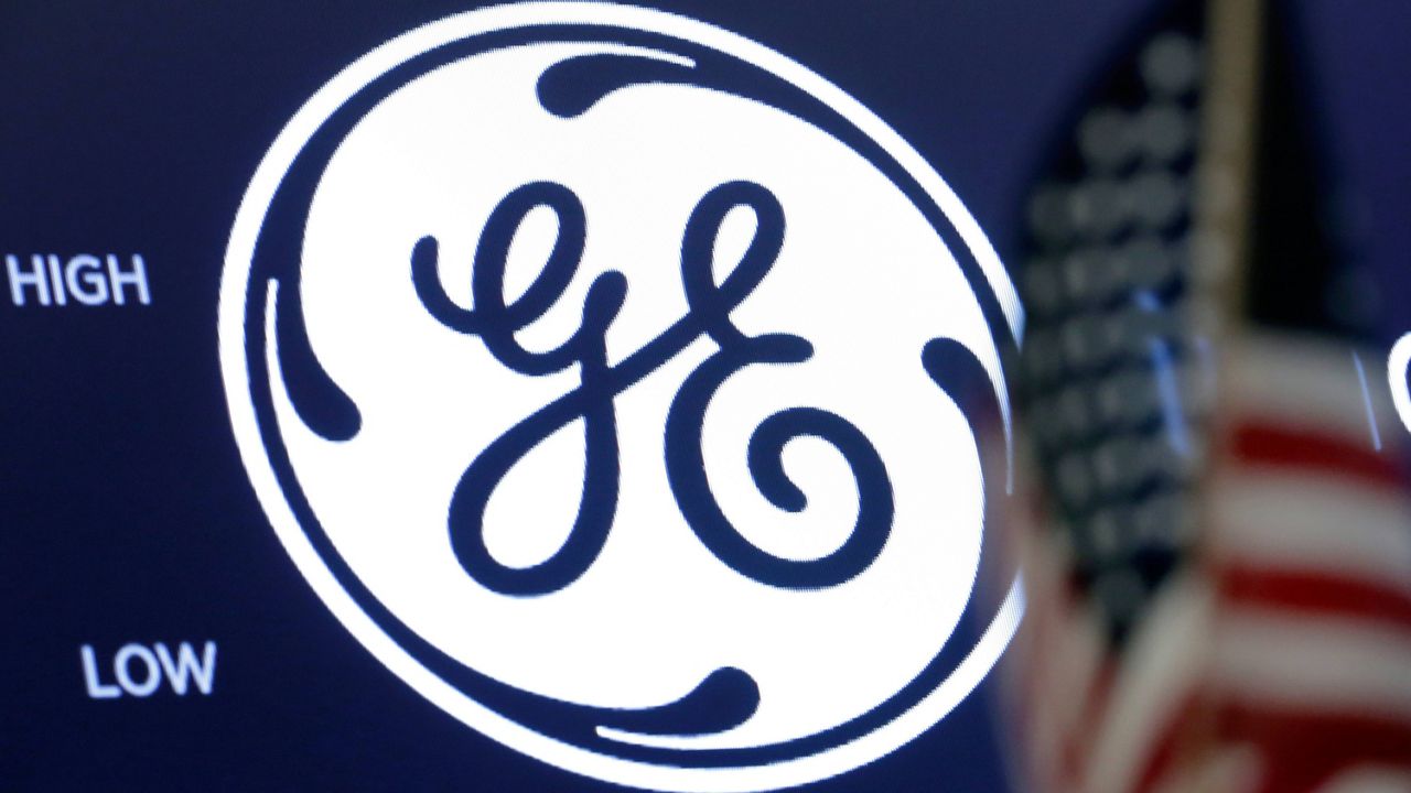 The General Electric logo appears above a trading post on the floor of the New York Stock Exchange. (AP Photo/Richard Drew, File)