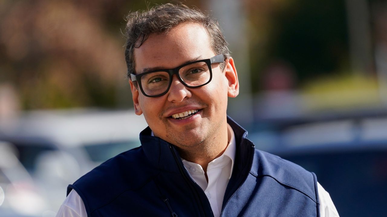 George Santos campaigns outside a store on Saturday, Nov. 5, 2022 in Glen Cove.