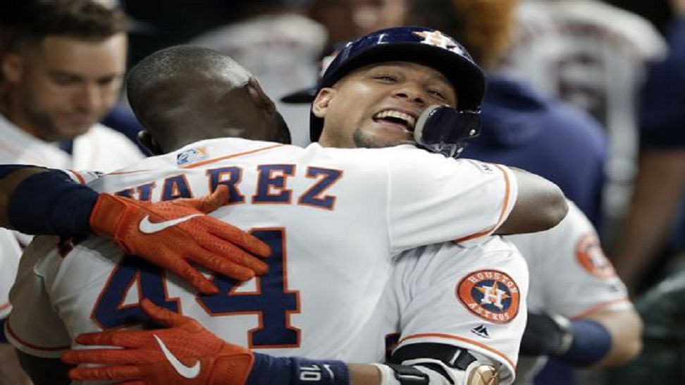 Houston Astros designated hitter Yordan Alvarez (44) hugs Yuli Gurriel in the dugout as they celebrate Gurriel's two-run home run during the fourth inning of a baseball game against the Tampa Bay Rays Wednesday, Aug. 28, 2019, in Houston. (AP Photo/Michael Wyke)