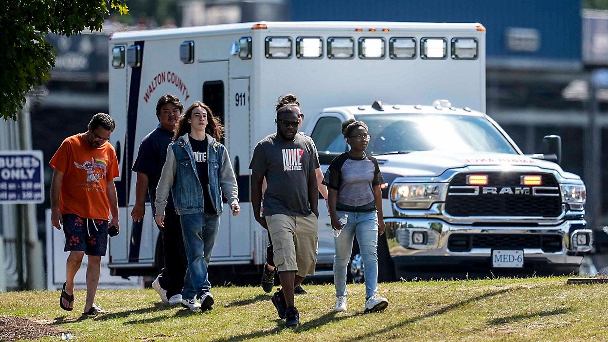 Students and parents walk off campus at Apalachee High School, Wednesday, Sept. 4, 2024, in Winder, Ga., after a shooting that left four dead.  (AP Photo/Mike Stewart)