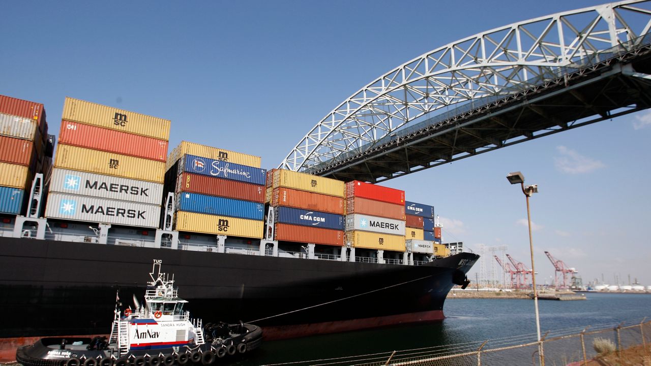 A cargo ship is guided into the the port of Long Beach under the Gerald Desmond bridge in Long Beach, Calif., Thursday, May 1, 2008. (AP Photo/Chris Carlson)