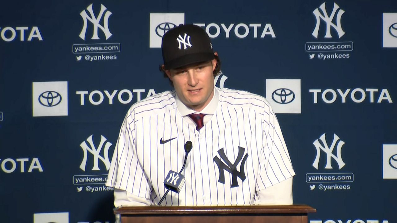 Manager Aaron Boone with Gerrit Cole and his wife Amy Cole as the New York  Yankees