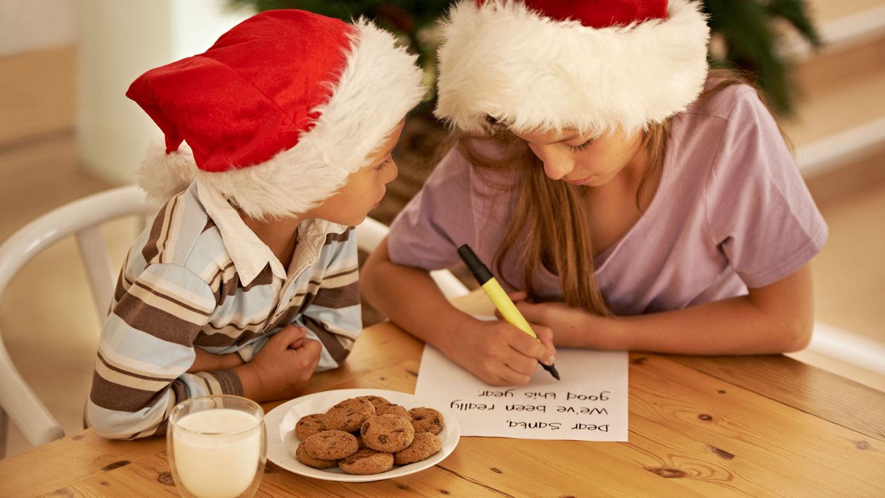 Stock image of two children writing a letter to Santa. (Getty Images)