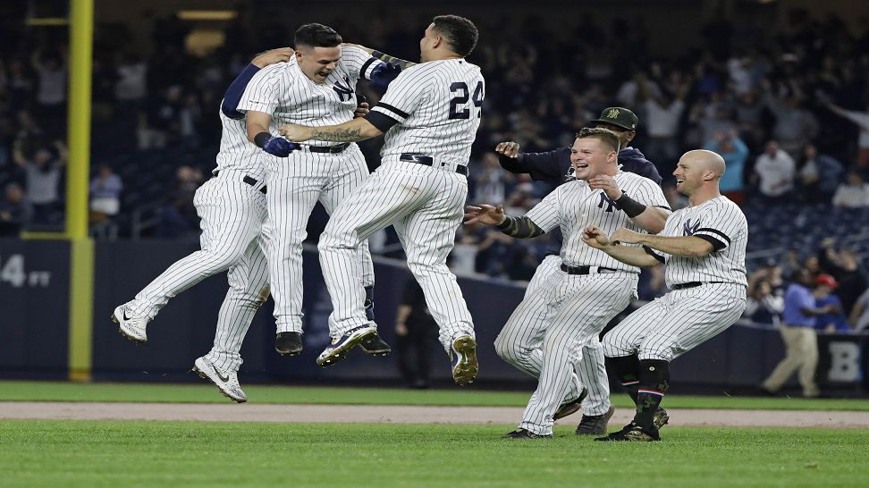 New York Yankees' Gio Urshela celebrates with teammates after hitting an RBI single during the ninth inning of the team's baseball game against the Tampa Bay Rays on Friday, May 17, 2019, in New York. The Yankees won 4-3. (AP Photo/Frank Franklin II)