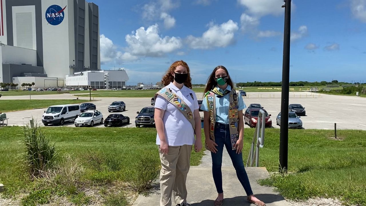Girls Scouts Evie Martell (left) and Marie Young (right) visit Kennedy Space Center ahead of the launch of three experiments created by Girls Scouts around the country.