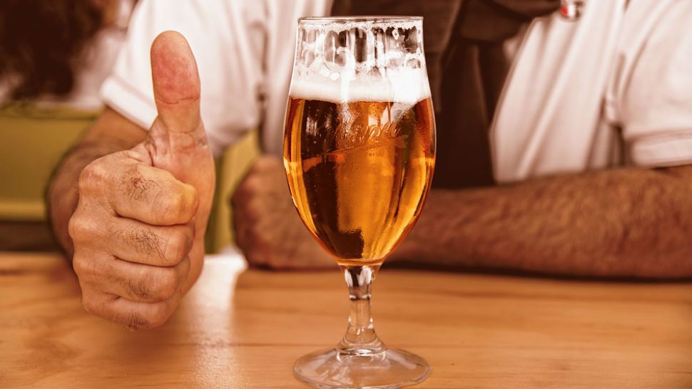 FILE- Beer and a thumbs up.