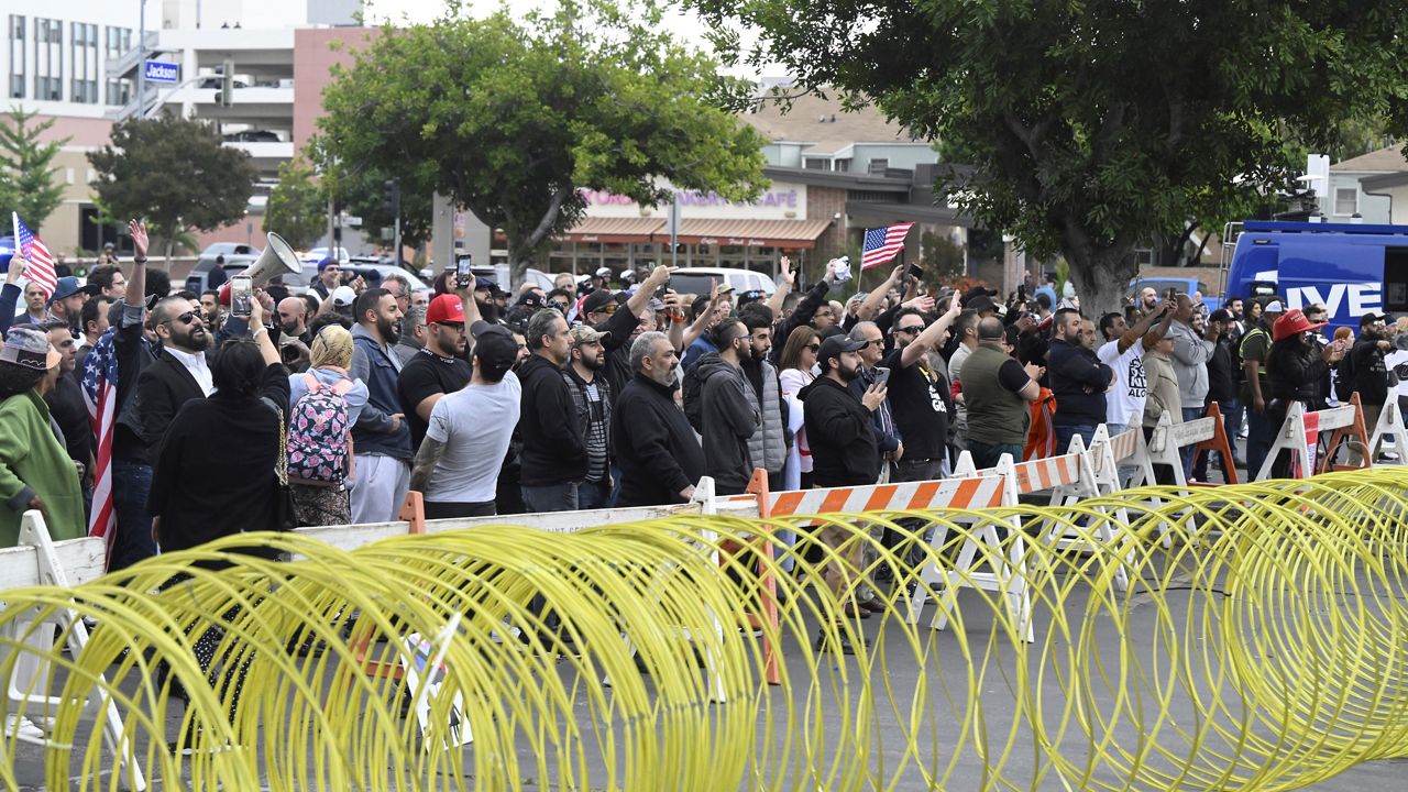 Conservative groups and LGBTQ+ rights supporters protest outside the Glendale Unified School District offices on June 6, 2023, in Glendale, Calif. (Keith Birmingham/The Orange County Register via AP)