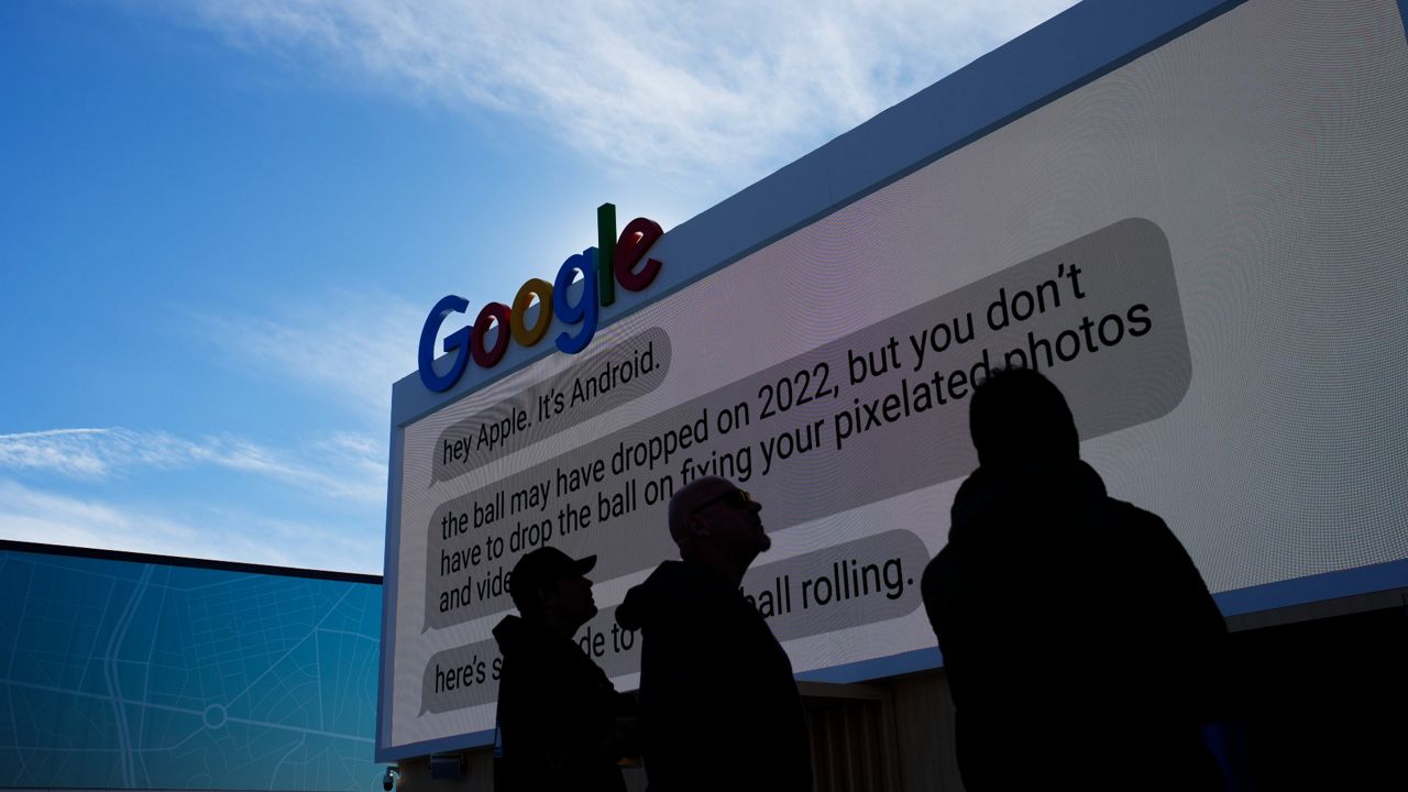 Workers help set up the Google booth at the Las Vegas Convention Center before the start of the CES tech show on Jan. 2. (AP Photo/John Locher)