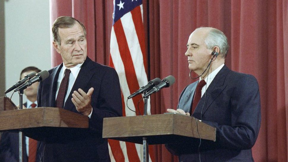 Bush gestures during a joint news conference with Soviet President Mikhail Gorbachev, at the Soviet Embassy in Madrid on Oct. 29, 1991. (AP Photo/Jerome Delay, File)