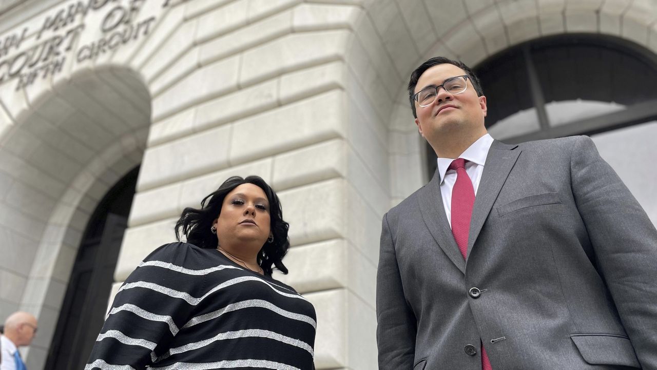 Priscilla Villarreal, an online journalist from Laredo, Texas, stands outside the 5th U.S. Circuit Court of Appeals building in New Orleans, Jan. 25, 2023, with her attorney, J.T. Morris, after the court heard arguments in Villarreal's lawsuit against Laredo and Webb County, Texas, authorities. A divided federal appeals court refused on Tuesday, Jan. 23, 2024, to revive the lawsuit of Villarreal, who said she was wrongfully arrested for seeking and obtaining nonpublic information from police in a case that drew attention from national media organizations and free speech advocates. (AP Photo/Kevin McGill, File)