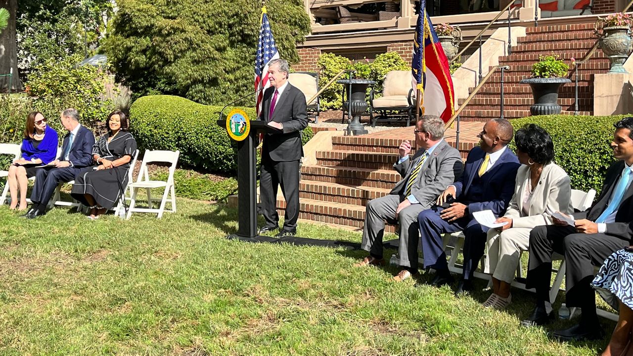 Gov. Roy Cooper on Friday announces that Wolfspeed Inc. will invest $5 billion in a Chatham County plant to make silicon carbide wafers. The Governor's Office said it will be the largest economic development investment in the state's history. (Photo: N.C. Governor's Office).