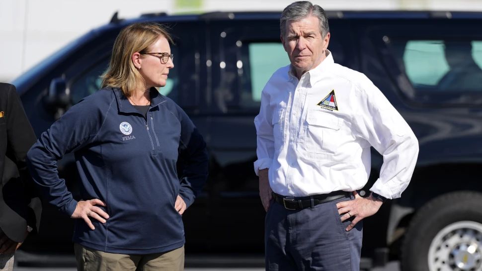 North Carolina Gov. Roy Cooper, right, and Deanne Criswell, Administrator of the U.S. Federal Emergency Management Agency, await the arrival of Democratic presidential nominee Vice President Kamala Harris for a briefing on the damage from Hurricane Helene, at Charlotte Douglas International Airport, Oct. 5, 2024, in Charlotte, N.C. (AP Photo/Chris Carlson, file)