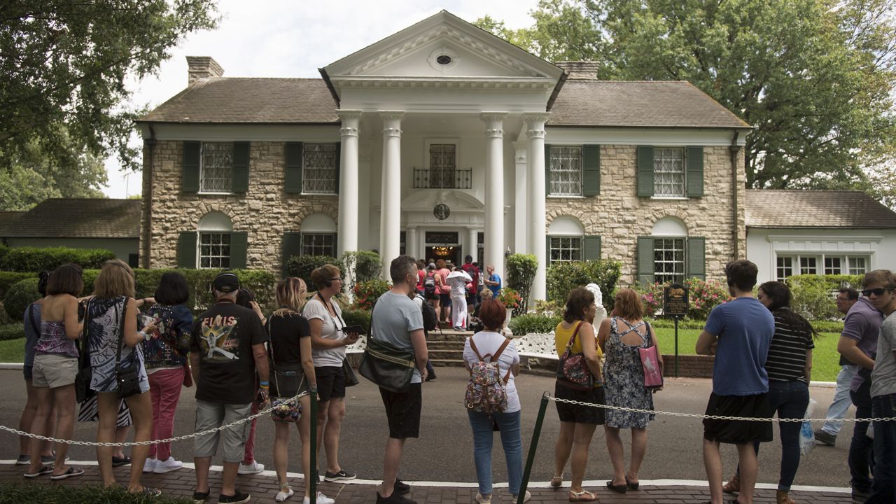 Fans wait in line outside Graceland Tuesday, Aug. 15, 2017, in Memphis, Tenn. (AP Photo/Brandon Dill, File)