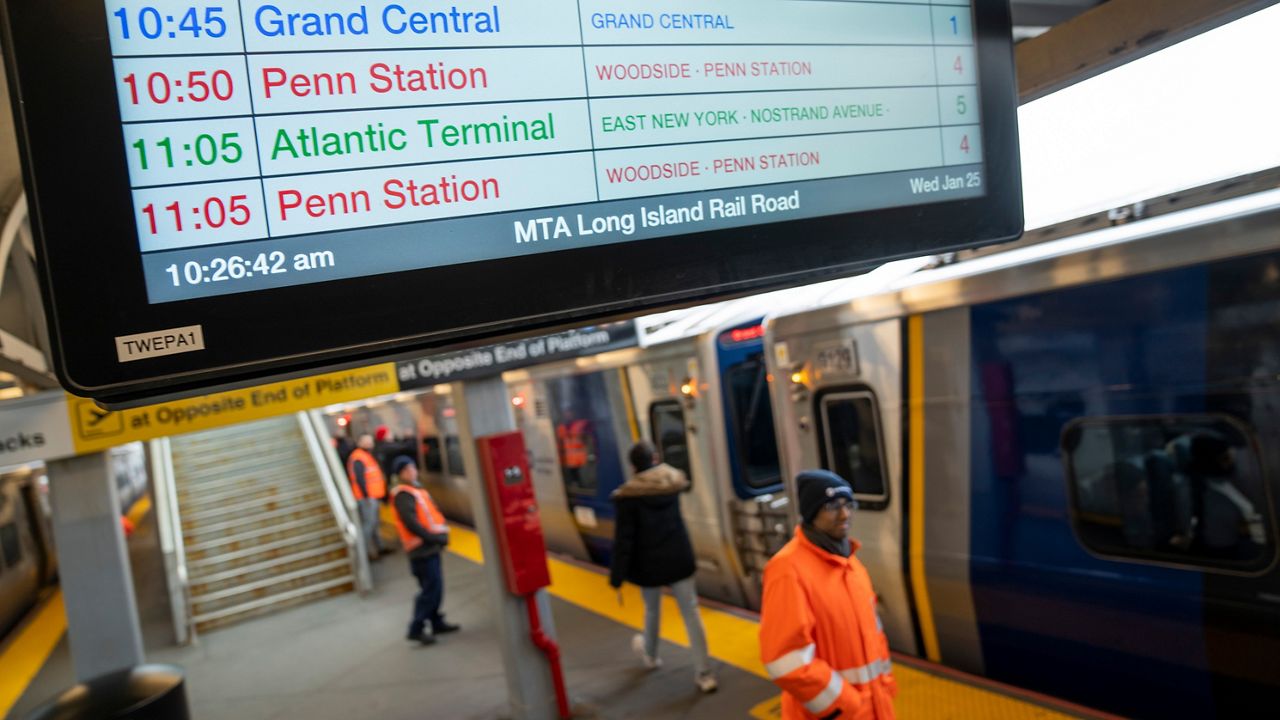 Passengers board a Long Island Rail Road train before it departs from Jamaica station towards Grand Central Terminal on Wednesday, Jan. 25, 2023.