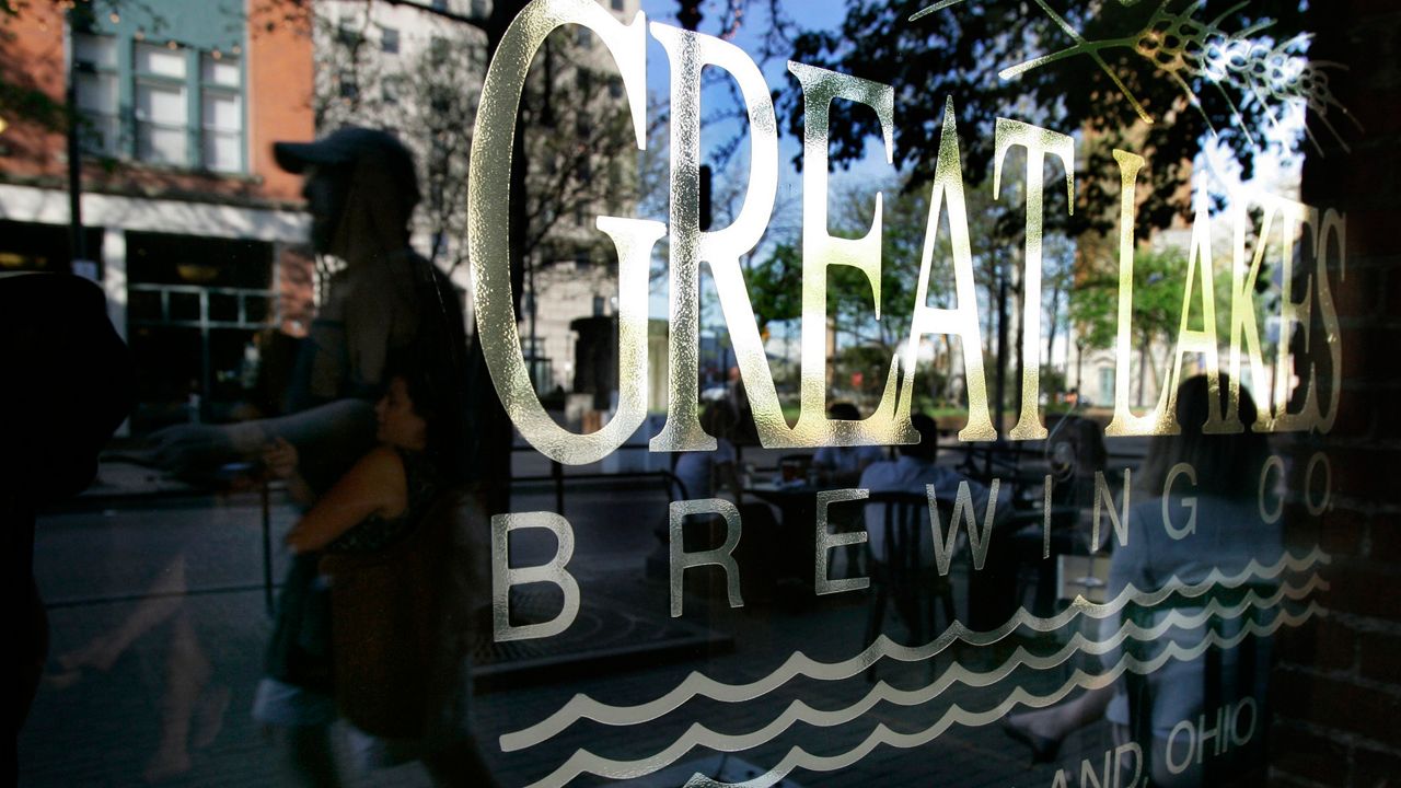 Customers are reflected in the front window of  the Great Lakes Brewing Company in Cleveland, Ohio. (AP Photo/Amy Sancetta)