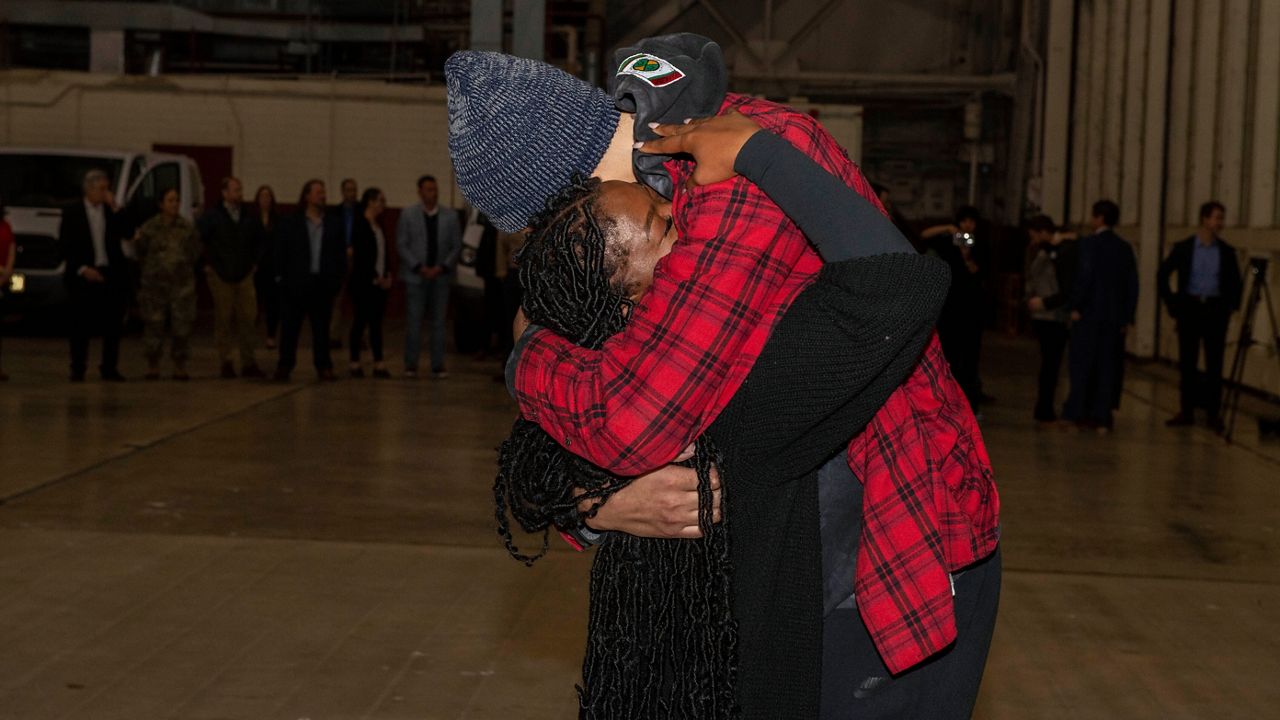 This photo provided by the U.S. Army shows WNBA star Brittney Griner, right, being greeted by wife Cherelle after arriving at Kelly Field in San Antonio following her release in a prisoner swap with Russia, Friday, Dec. 9, 2022. (Miquel A. Negron/U.S. Army via AP)