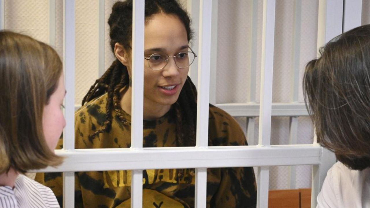 WNBA star and two-time Olympic gold medalist Brittney Griner speaks to her lawyers standing in a cage at a court room prior to a hearing, in Khimki just outside Moscow, Russia, Tuesday, July 26, 2022. American basketball star Brittney Griner returns Tuesday to a Russian courtroom for her drawn-out trial on drug charges that could bring her 10 years in prison of convicted. (AP Photo/Alexander Zemlianichenko, Pool)
