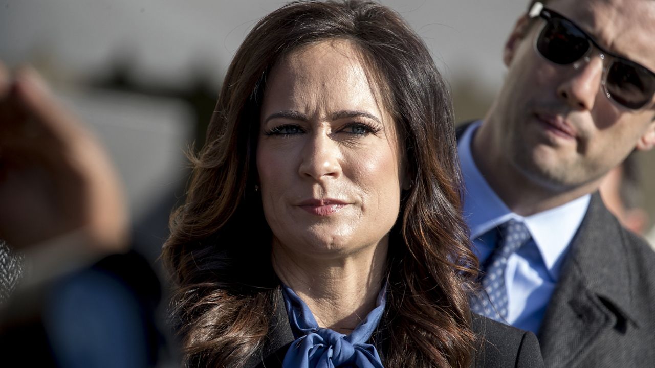 White House press secretary Stephanie Grisham listens as President Donald Trump speaks to reporters on the South Lawn of the White House in Washington, Friday, Nov. 8, 2019, before boarding Marine One for a short trip to Andrews Air Force Base, Md. and then on to Georgia to meet with supporters. (AP Photo/Andrew Harnik)