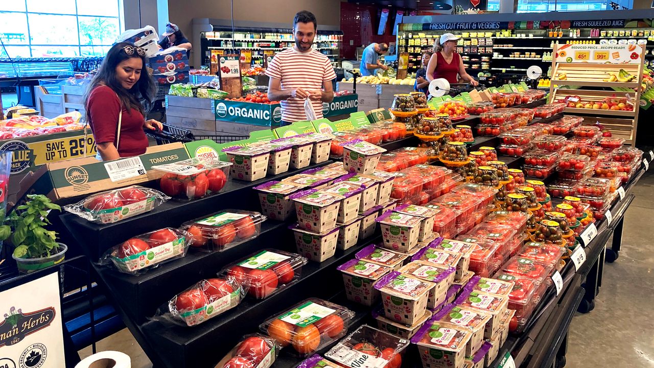 Shoppers shop at a grocery store in Glenview, Ill., Monday, July 4, 2022. U.S. demand for grocery delivery is cooling as food prices rise. Some shoppers are shifting to less expensive grocery pickup, while others are returning to the store. (AP Photo/Nam Y. Huh)
