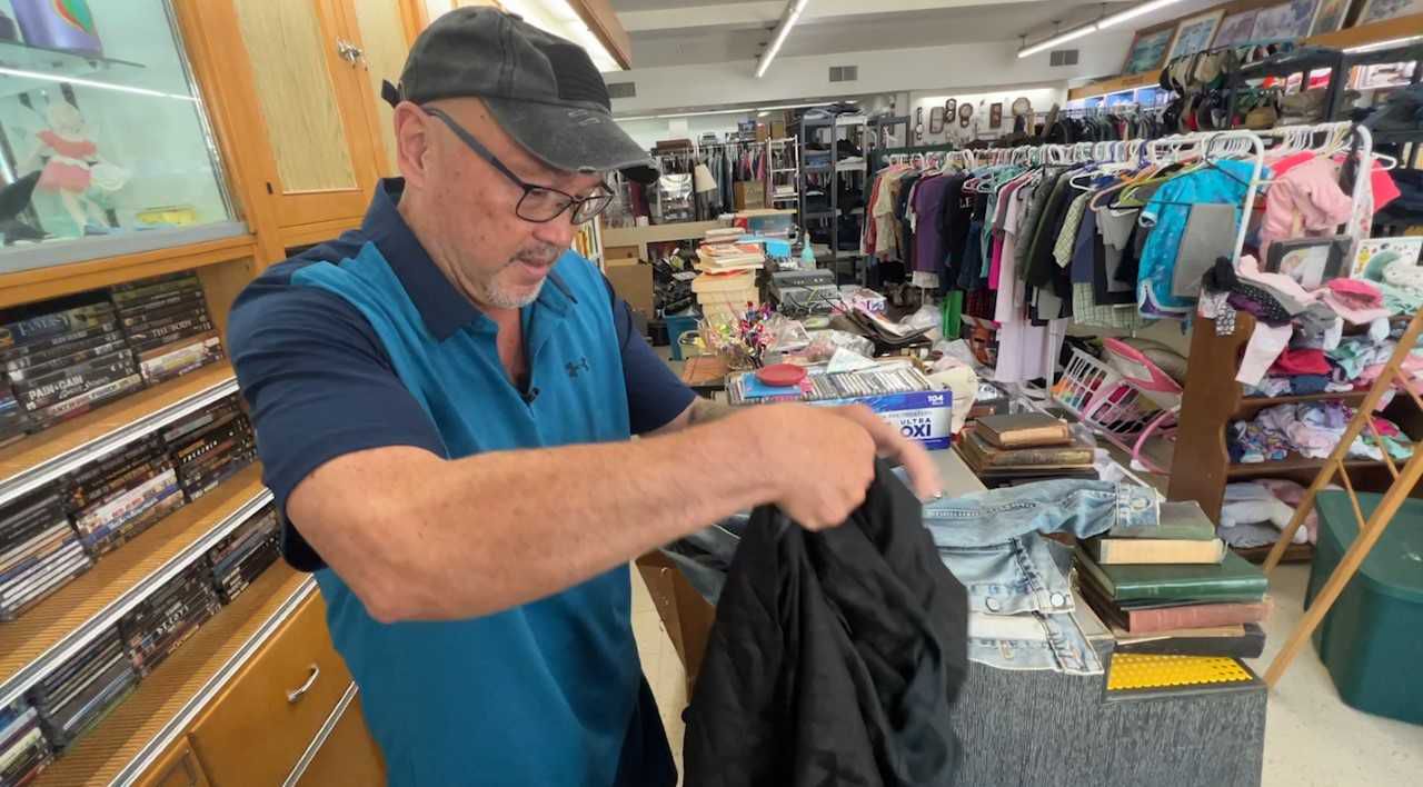 Carl McDaniel goes through donations at thrift store in Union Grove. (Spectrum News 1/Megan Marshall)