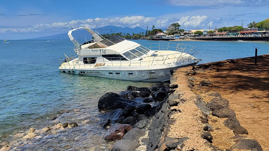 The "Kuuipo" sits near a sacred Hawaiian cultural site (black rocks). DOBOR took control of the vessel on Saturday to avoid damaging the site. (DLNR/Mapuana Makaiwi)
