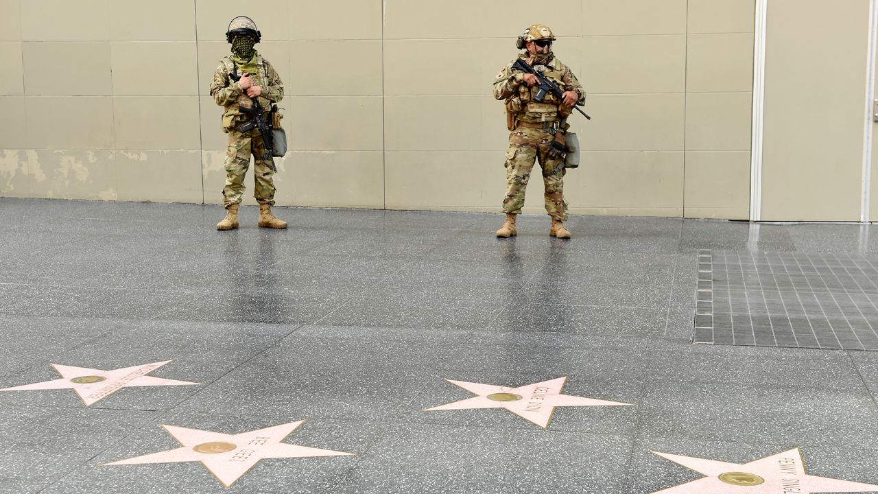 U.S. National Guardsmen watch over the Hollywood Walk of Fame, Sunday, May 31, 2020, in Los Angeles. Protests were held in U.S. cities over the death of George Floyd, a black man who died after being restrained by Minneapolis police officers on May 25. (AP Photo/Chris Pizzello)