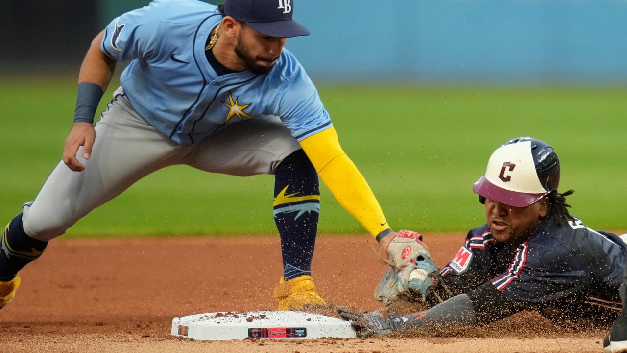 Cleveland Guardians' Jose Ramirez, right, slides safely into second base under the tag of Tampa Bay Rays second baseman Jose Caballero, left, inning of a baseball game, Friday, Sept. 13, 2024, in Cleveland.