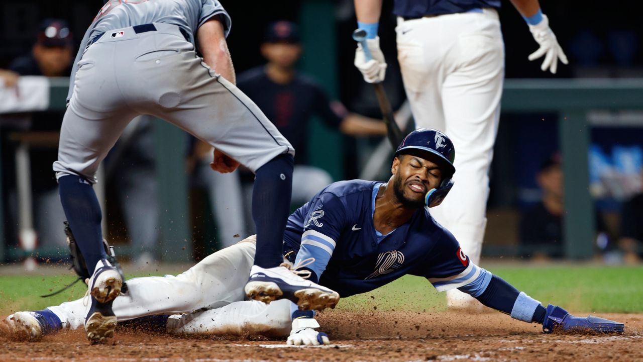 Cleveland Guardians pitcher Darren McCaughan, left, is late with the tag as Kansas City Royals' Maikel Garcia scores on a wild pitch during the eighth inning of a baseball game in Kansas City, Mo., Friday, June 28, 2024.