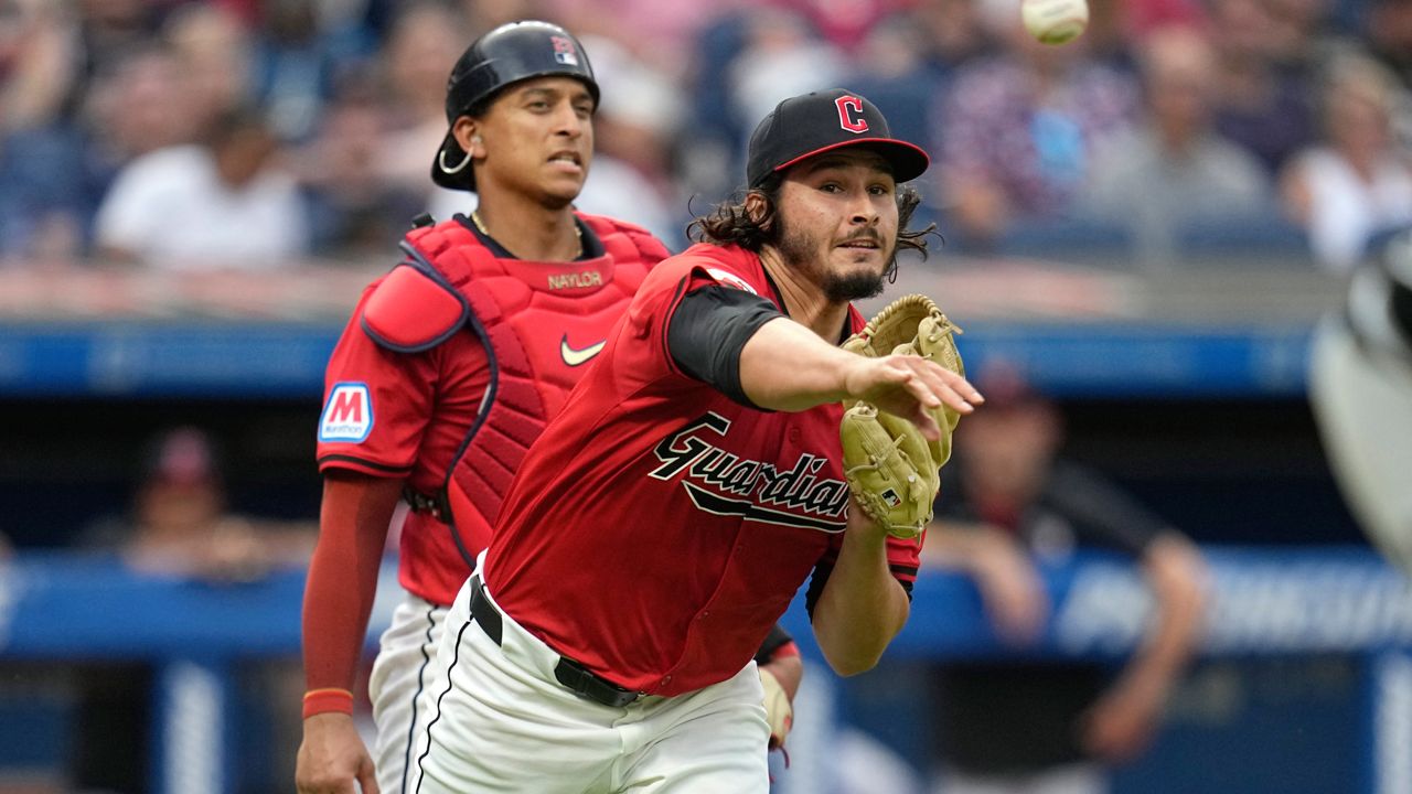 Cleveland Guardians pitcher Eli Morgan, right, throws out Chicago White Sox's Martin Maldonado at first base in the sixth inning of a baseball game Wednesday, July 3, 2024, in Cleveland. 