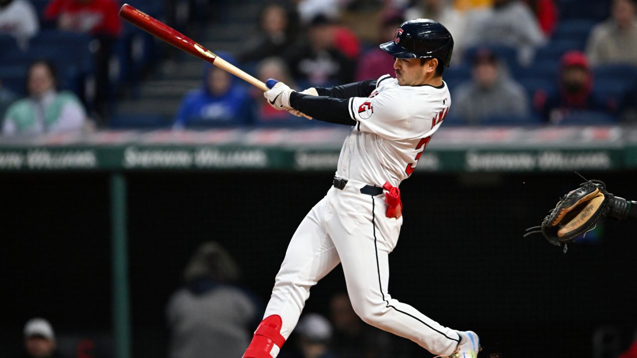 Cleveland Guardians' Steven Kwan follows through on a two-run double against the Oakland Athletics during the fifth inning of a baseball game Friday, April 19, 2024, in Cleveland.