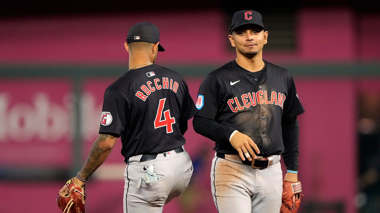 Cleveland Guardians' Brayan Rocchio (4) and Andres Gimenez celebrate after their baseball game against the Kansas City Royals Tuesday, Sept. 3, 2024, in Kansas City, Mo. The Guardians won 7-1. (AP Photo/Charlie Riedel)