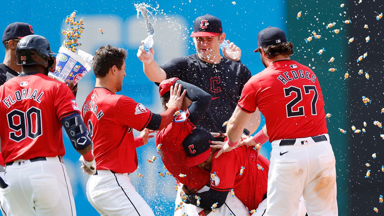 Cleveland Guardians' Brayan Rocchio is mobbed by teammates after hitting the game-winning RBI single off Detroit Tigers pitcher Alex Lange in the 10th inning of a baseball game, Wednesday, May 8, 2024, in Cleveland. (AP Photo/Ron Schwane)