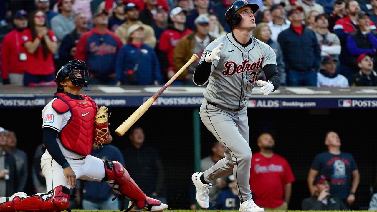 Cleveland Guardians catcher Bo Naylor, left, and Detroit Tigers' Kerry Carpenter, right, watch Carpenter's three-run home run in the ninth inning during Game 2 of baseball's AL Division Series, Monday, Oct. 7, 2024, in Cleveland. (AP Photo/Phil Long)