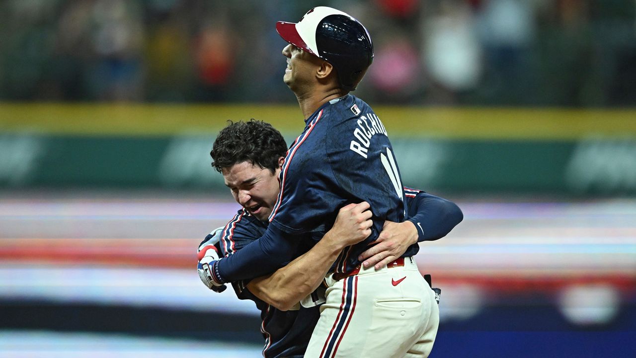 Cleveland Guardians' Brayan Rocchio is hugged by Will Brennan after hitting a walk-off single during the tenth inning of a baseball game against the Minnesota Twins, Wednesday, Sept. 18, 2024, in Cleveland. (AP Photo/David Dermer)