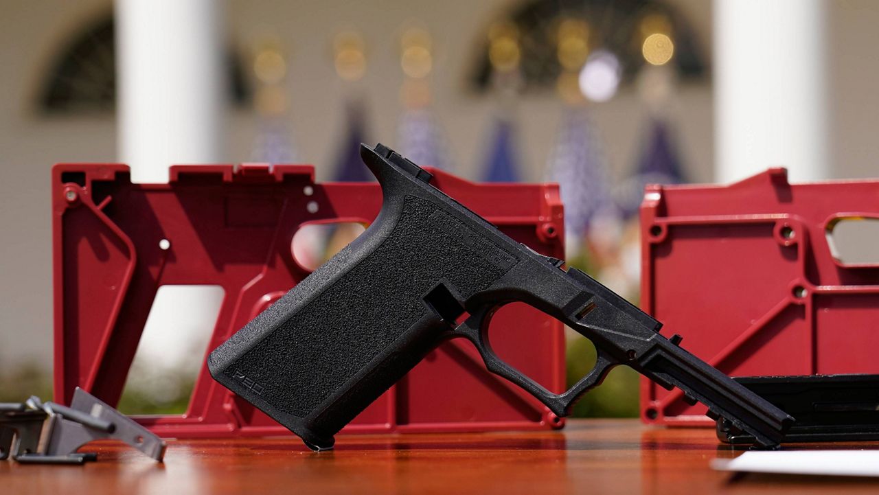 A 9mm pistol build kit with a commercial slide and barrel with a polymer frame is displayed before President Joe Biden and Deputy Attorney General Lisa Monaco speak in the White House Rose Garden on April 11. (AP Photo/Carolyn Kaster, File)